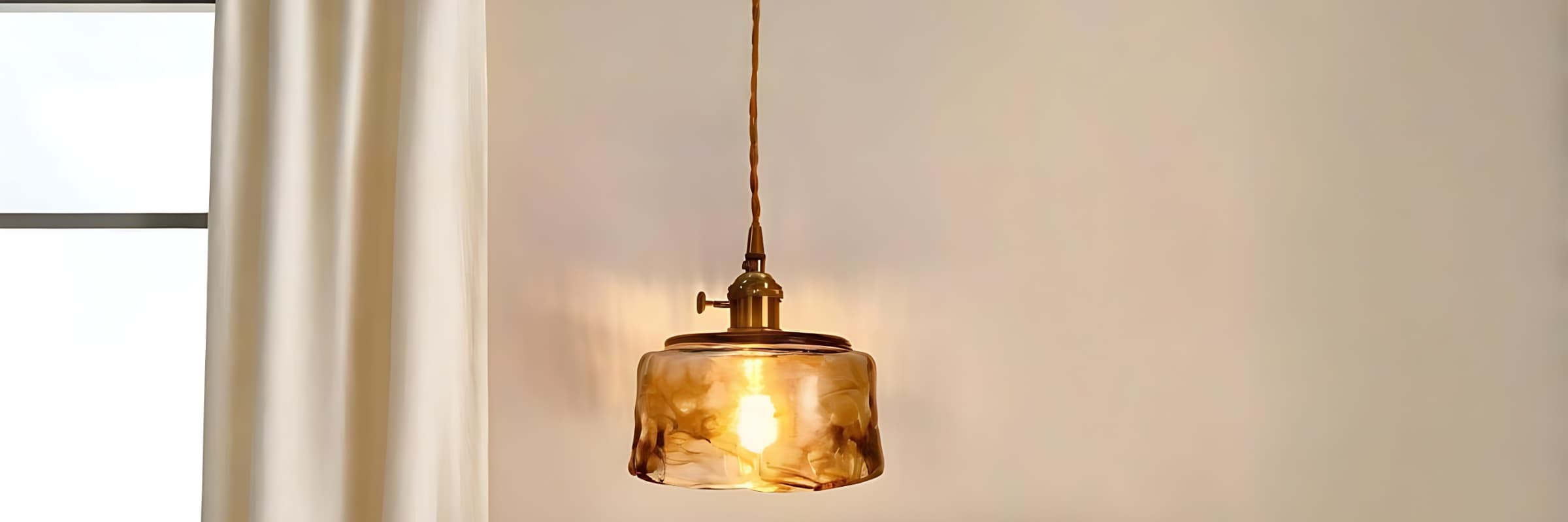 Amber glass pendant light near a windowslider_item_2